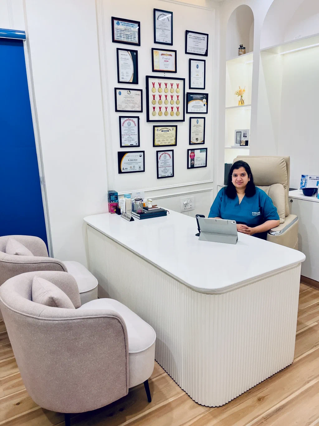 Dr. Shikha Bansal in her consultation room surrounded by credentials and awards