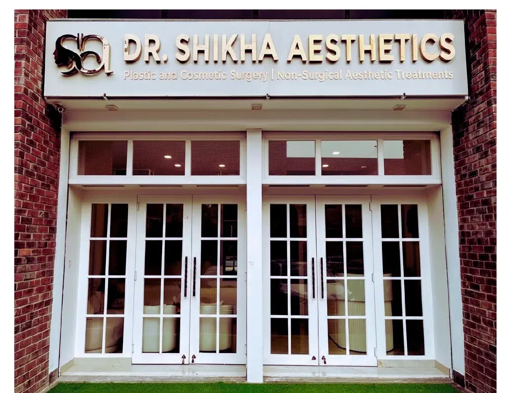 The clinic entrance in Sushant Lok 1, with white doors and the sign