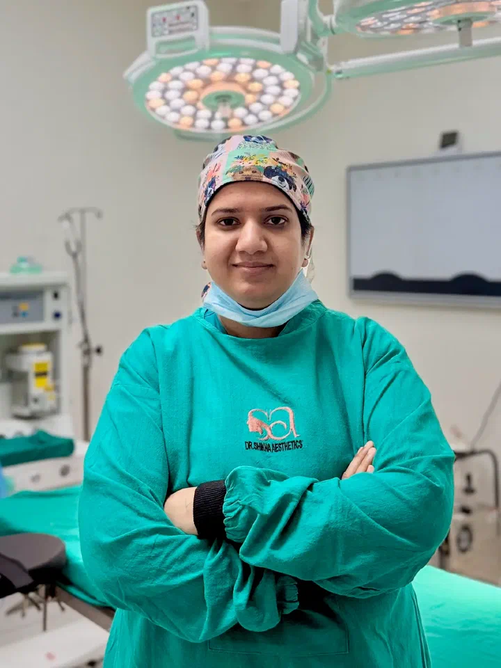 Dr. Shikha Bansal in green theatre scrubs and cap, arms folded, in the operating theatre